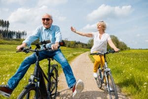 later life couple on bikes discussing equity release lifetime mortgages